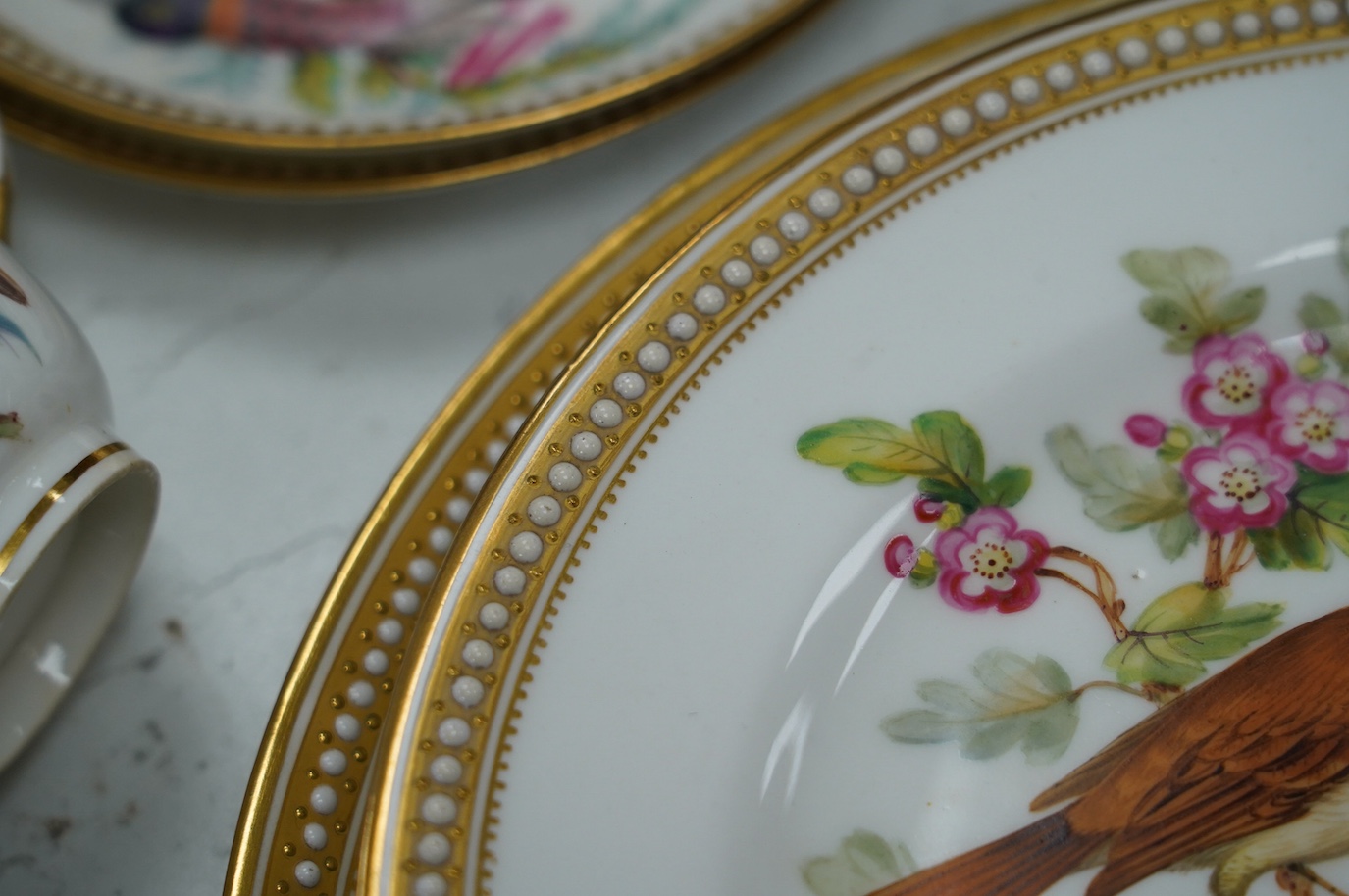 A 19th century Royal Worcester ornithologically decorated part tea set, with gilt and jewelled edges, six place setting. Condition - good